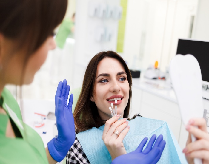 A dentist from Reiser Dental is providing porcelain veneer treatment to a patient in Denver, CO